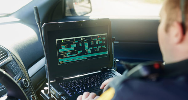 looking over shoulder of person in vehicle looking at computer screen interface